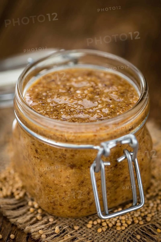 Fresh made German Cuisine (sweet Mustard) on a vintage background (close-up shot)
