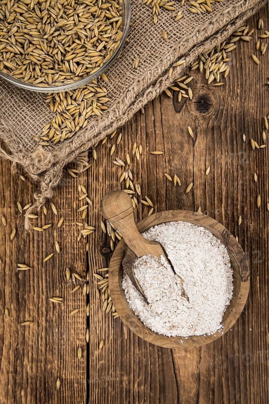 Portion of fresh Oat Flour on an old wooden table