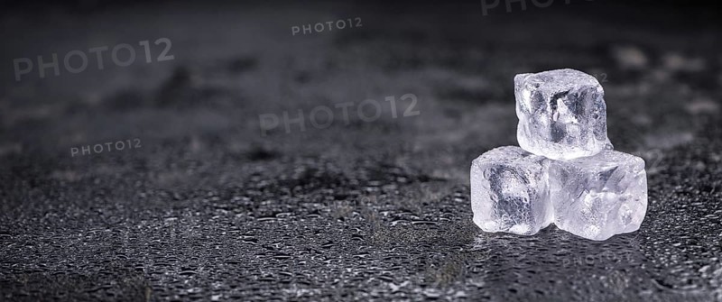 Some melting Ice cubes on a vintage slate slab (selective focus)