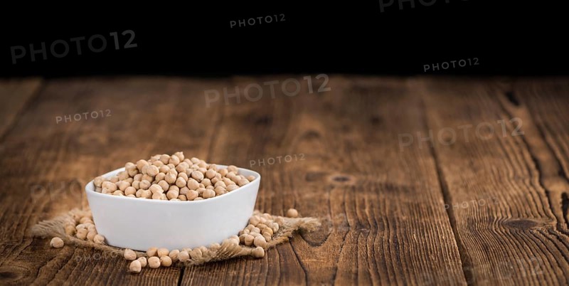 Chickpeas on a vintage background as detailed close-up shot, selective focus
