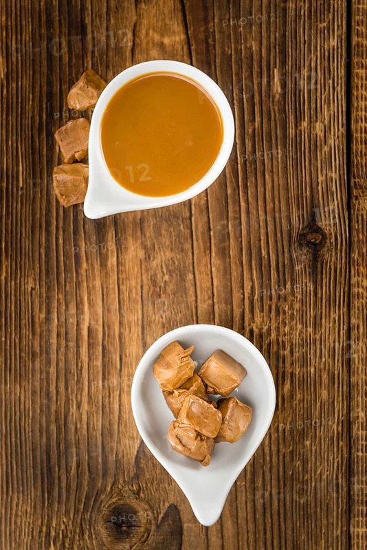 Caramel Sauce on a vintage background as detailed close-up shot (selective focus)