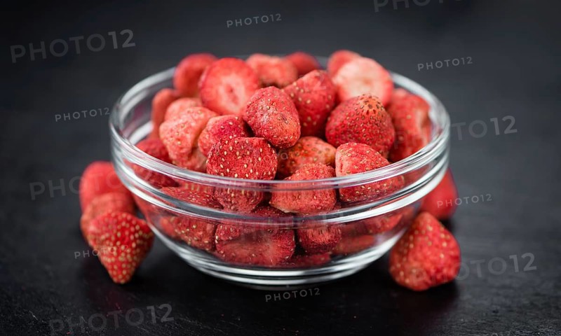 Some fresh Dried Strawberries on a vintage slate slab, selective focus, close-up shot