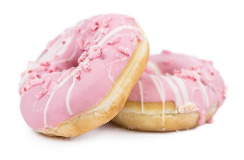 Some fresh made Donuts isolated on white background (close-up shot)