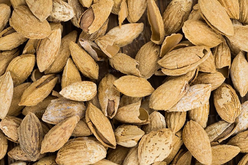 Roasted Almonds (in shell) as full size background image (selective focus)
