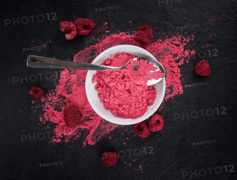Fresh made Raspberry powder on a vintage background as detailed close-up shot