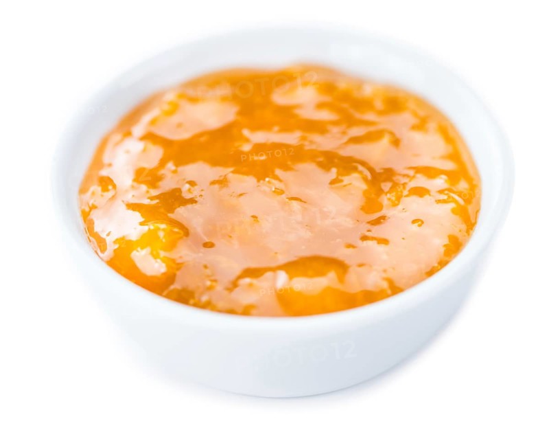 Portion of fresh made Apricot Jam isolated on white background
