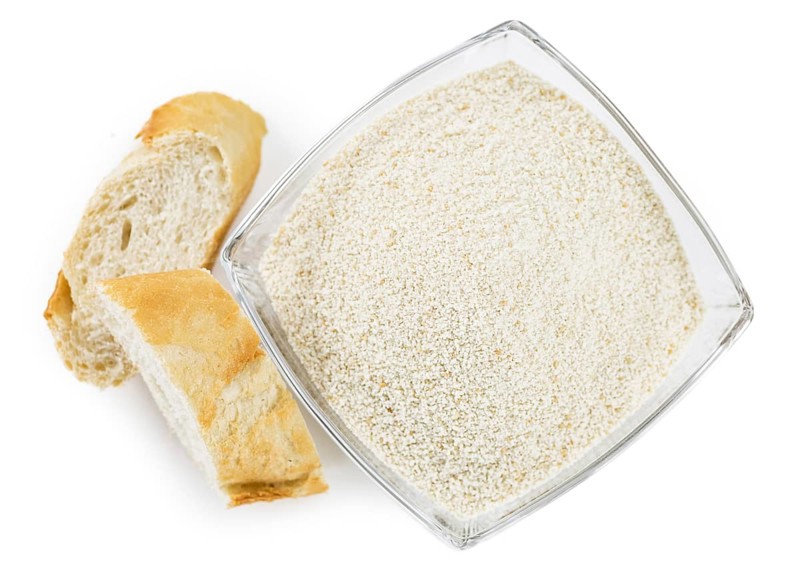 Breadcrumbs as detailed close-up shot isolated on white background (selective focus)