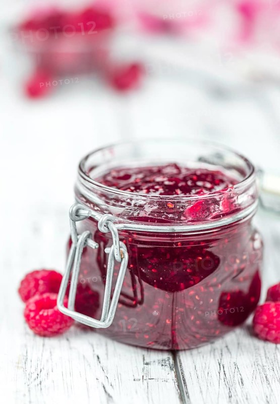 Fresh made Raspberry Jam on a vintage background as detailed close-up shot