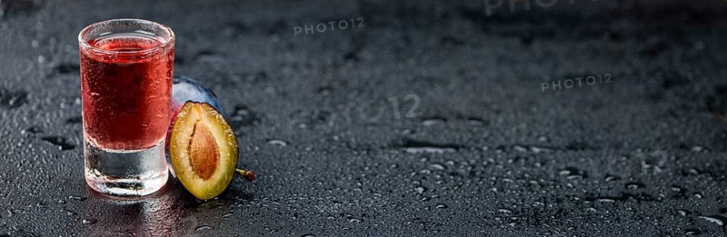 Plum Liqueur on a vintage slate slab as detailed close-up shot, selective focus