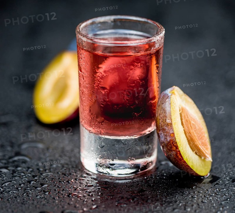 Fresh made Plum Liqueur on a vintage background as detailed close-up shot