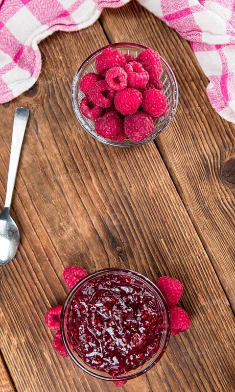 Fresh made Raspberry Jam on a vintage background as detailed close-up shot