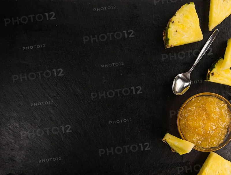 Portion of Pineapple Jam on a rustic slate slab, selective focus, close-up shot