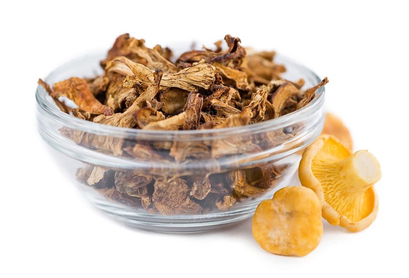 Portion of Dried Chanterelles as detailed close-up shot isolated on white background