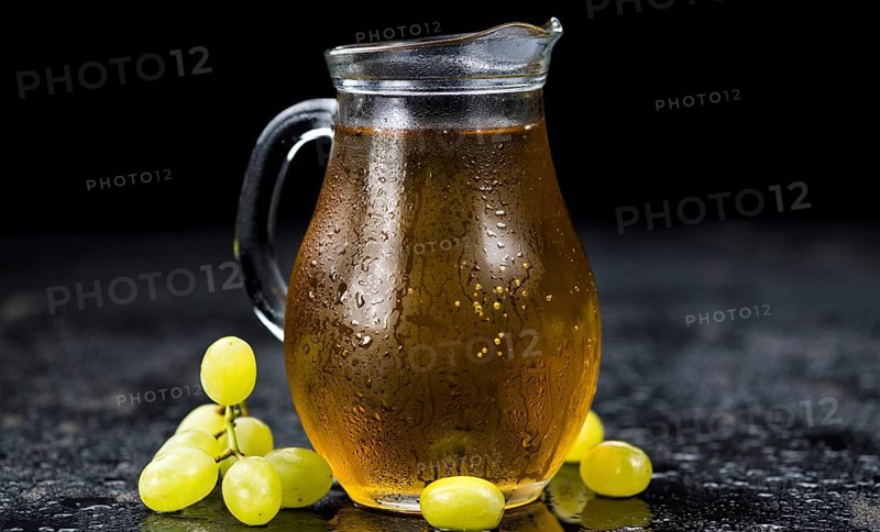 Some healthy Grape Juice on a vintage slate slab (selective focus)