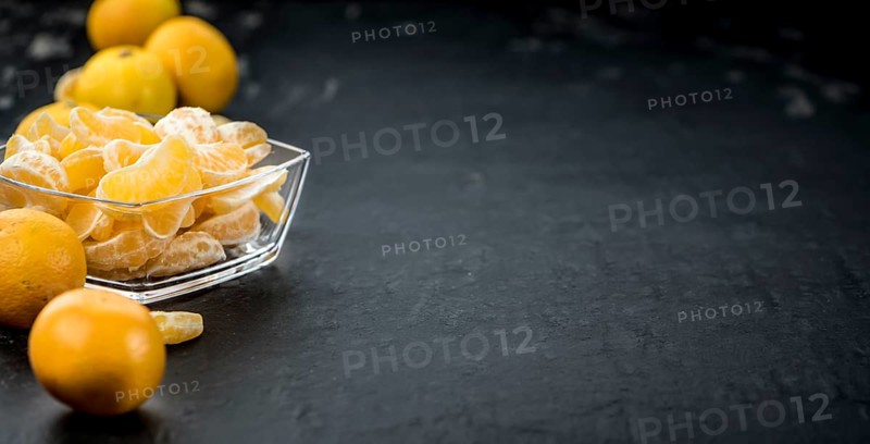 Raw Tangerine pieces (close-up shot) on vintage background