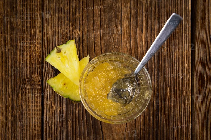 Fresh made Pineapple Jam on an old and rustic wooden table, selective focus, close-up shot