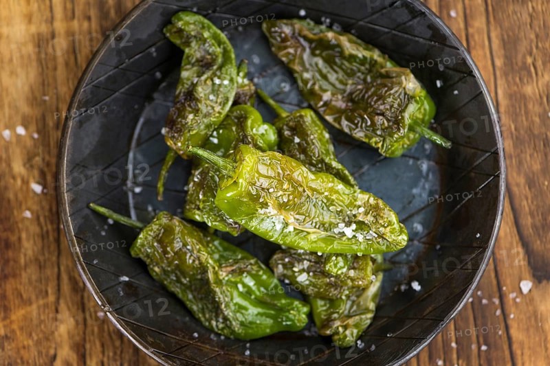 Portion of fresh Pimientos de Padron close-up shot, selective focus