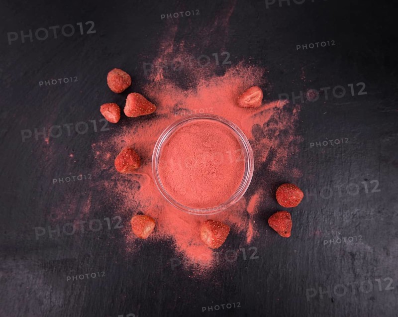 Portion of Strawberry powder as detailed close up shot on a slate slab, selective focus
