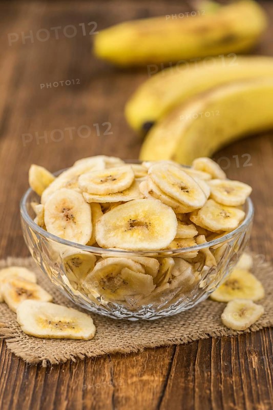 Dried Banana Chips on a vintage background as detailed close-up shot, selective focus