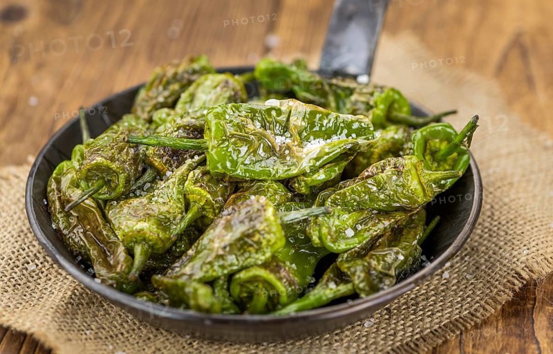 Pimientos de Padron on a vintage background as detailed close-up shot, selective focus