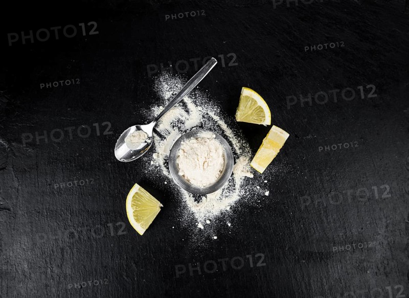 Portion of healthy Lemon powder on a slate slab (selective focus)