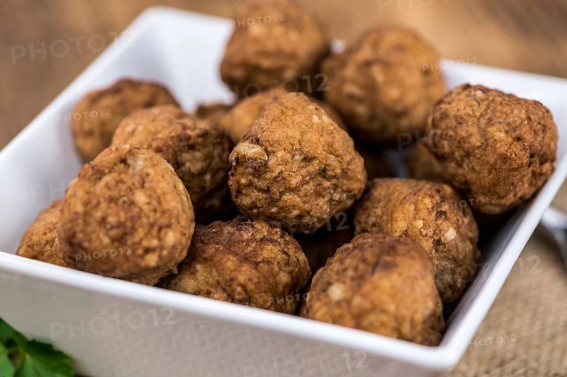 Some fresh made Meatballs on wooden background (selective focus, close-up shot)