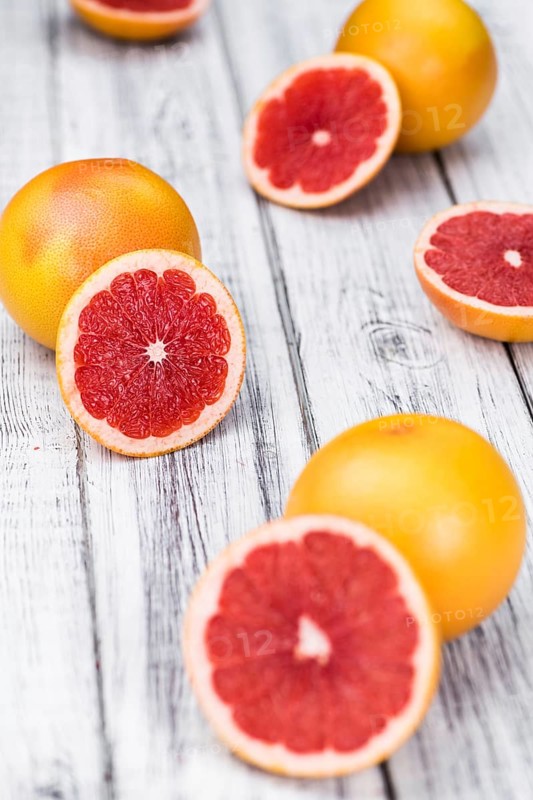 Chopped Grapefruits (selective focus) on a vintage background as detailed close-up shot