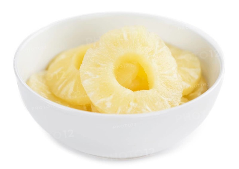 Portion of Preserved Pineapple Rings as detailed close-up shot isolated on white background