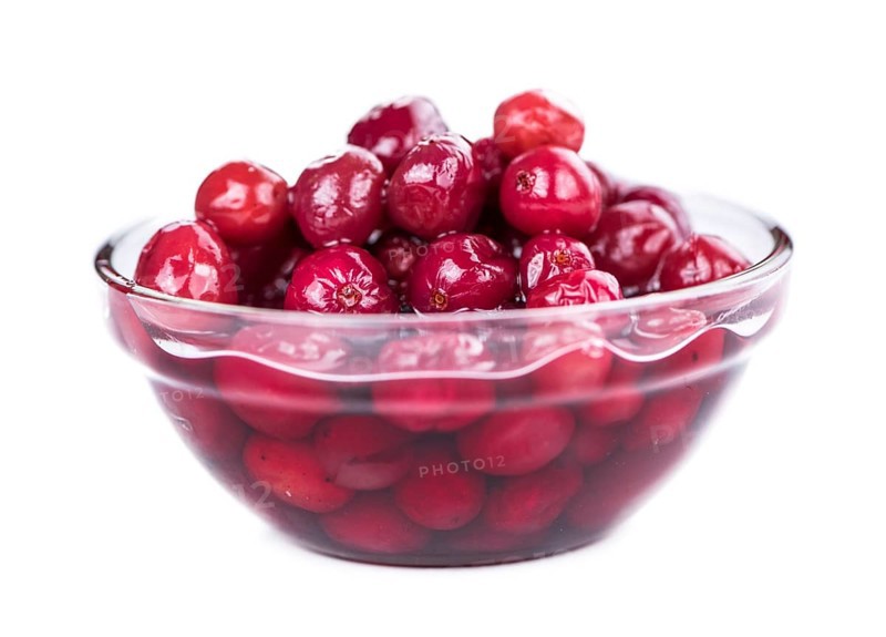 Cranberries (preserved) isolated on white background (selective focus, close-up shot)