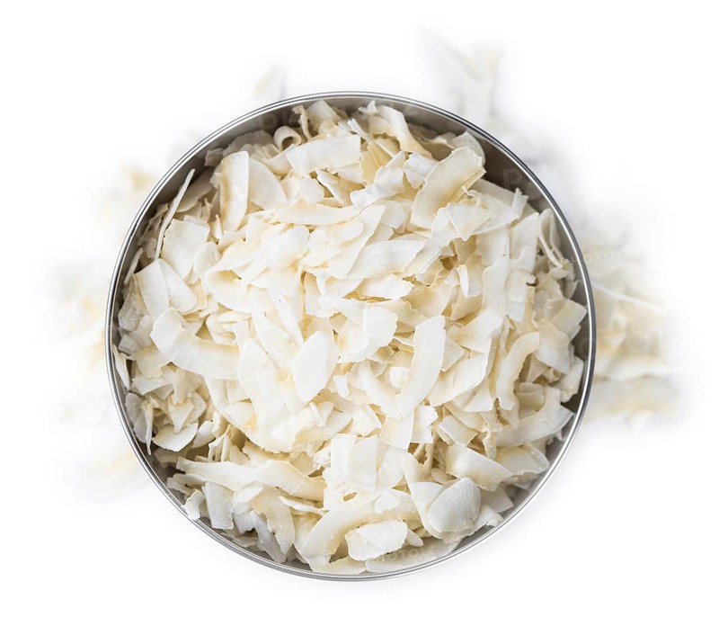 Portion of Coconut Chips isolated on white background (selective focus)