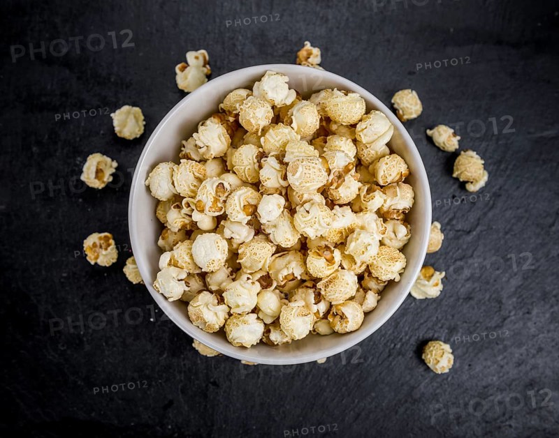 Some Popcorn on a slate slab as detailed close-up shot, selective focus