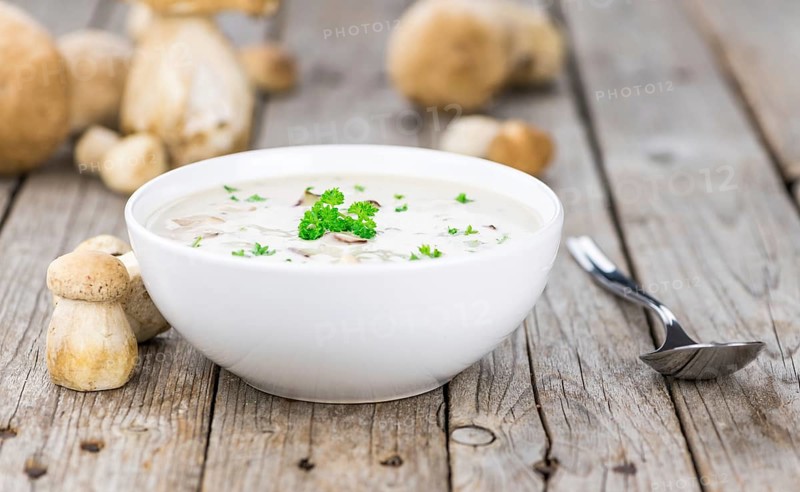 Homemade Porcini Soup on vintage background selective focus, close-up shot