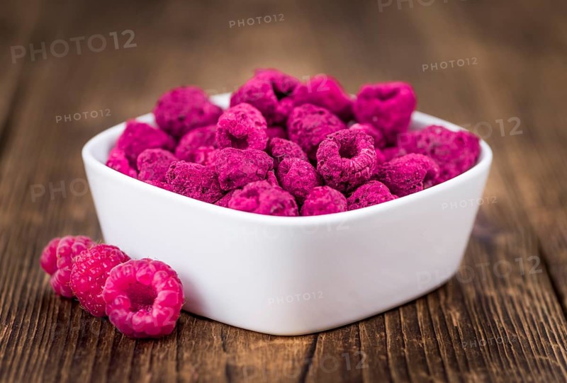 Fresh made Raspberries (dried) on an old and rustic wooden table, selective focus, close-up shot