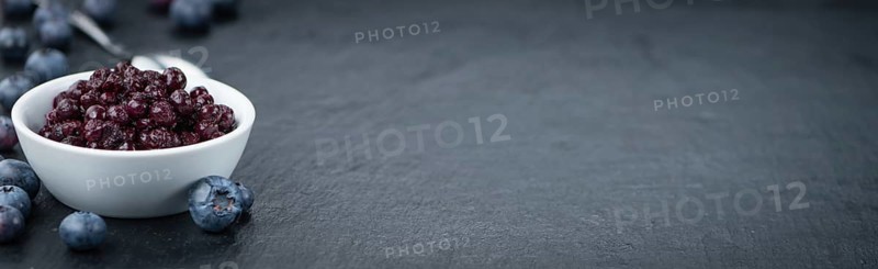 Preserved Blueberries on a vintage background as detailed close-up shot, selective focus