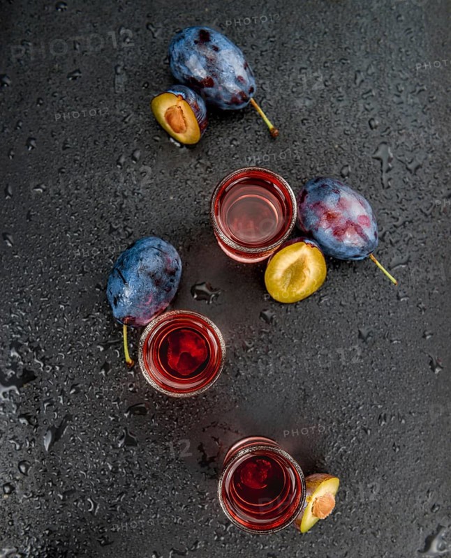 Plum Liqueur on a vintage slate slab as detailed close-up shot, selective focus