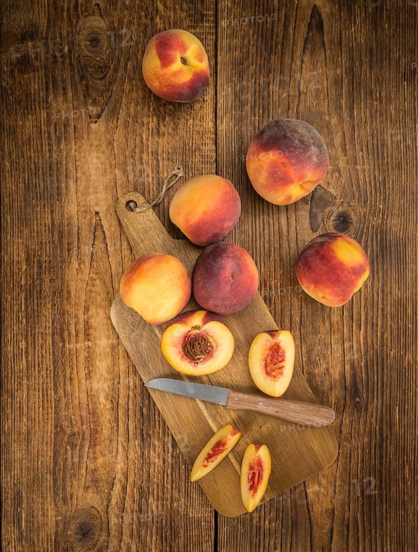 Peaches on a vintage background as detailed close-up shot, selective focus