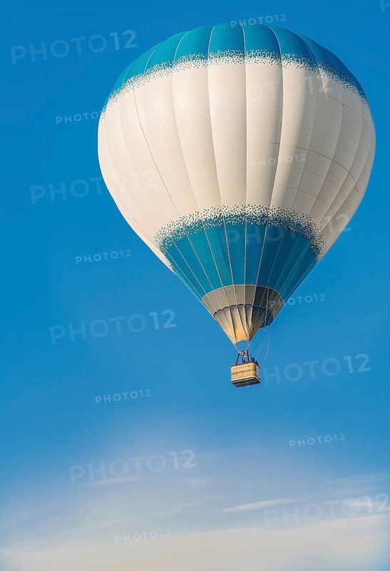 A hot air balloon with a blue and white pattern floats peacefully in a clear blue sky, Belarus, Minsk, Europe