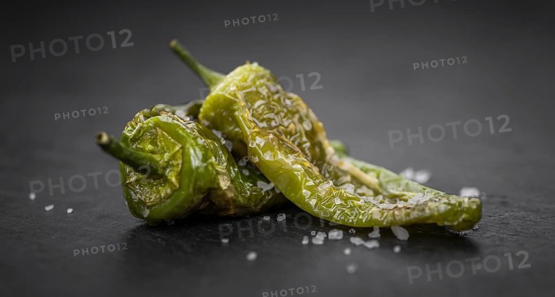 Pimientos de Padron on a vintage background as detailed close-up shot, selective focus