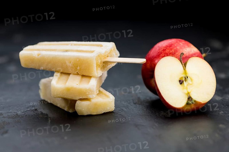 Portion of homemade Apple Popsicles (selective focus, close-up shot) on a vintage background