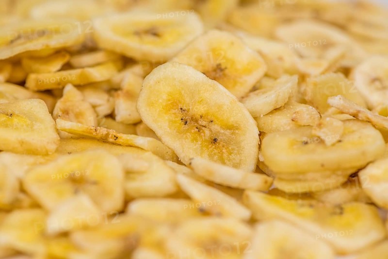 Fresh made Dried Banana Chips on an old and rustic wooden table, selective focus, close-up shot