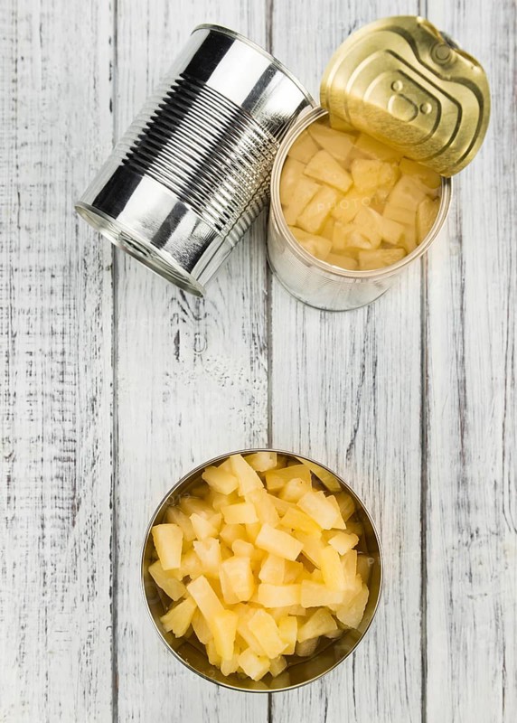 Fresh made Chopped Pineapple (preserved) on an old and rustic wooden table, selective focus, close-up shot