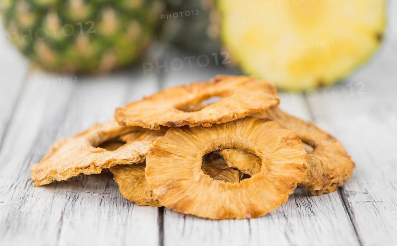 Dried Pineapple Rings on a vintage background as detailed close-up shot, selective focus