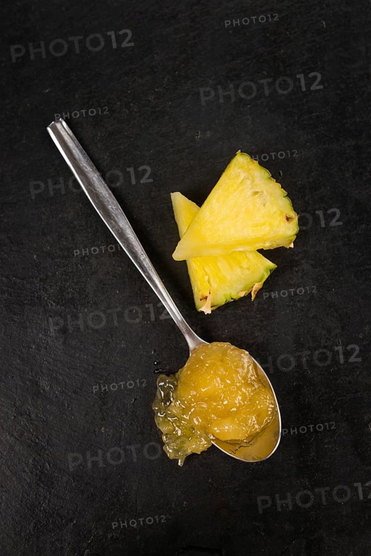 Portion of Pineapple Jam on a rustic slate slab, selective focus, close-up shot