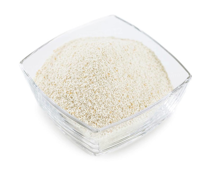 Bread Crumbs isolated on white background (selective focus, close-up shot)