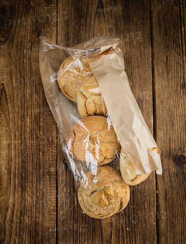 Fresh made German Buns on an old and rustic wooden table, selective focus, close-up shot