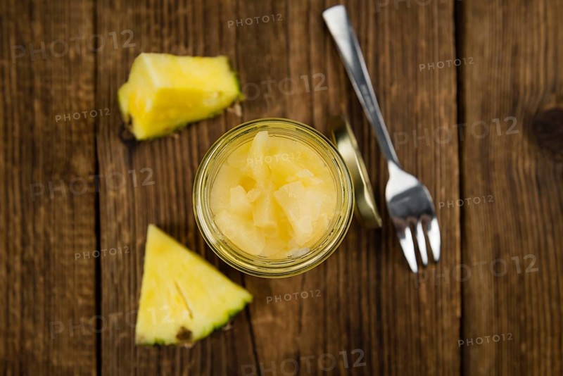 Fresh made Chopped Pineapple (preserved) on an old and rustic wooden table, selective focus, close-up shot