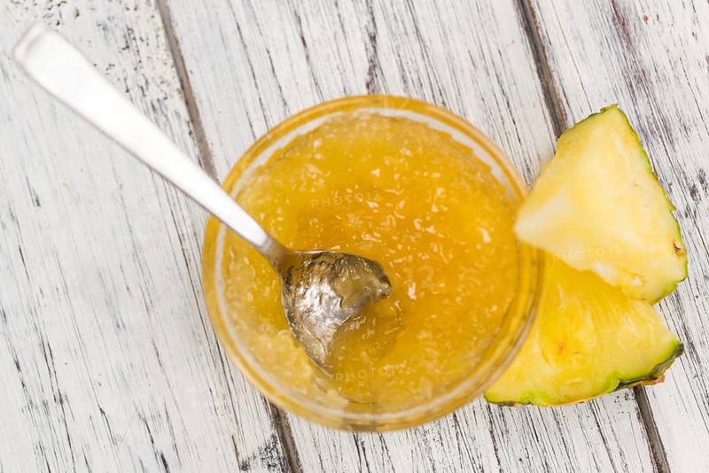 Fresh made Pineapple Jam on a vintage background as detailed close-up shot