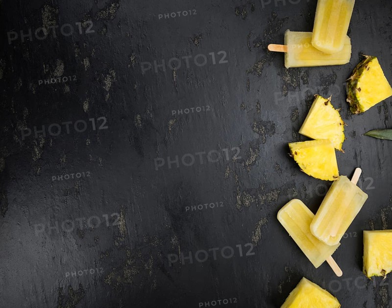 Fresh made Popsicles (Pineapple flavoured, selective focus) on a rustic background
