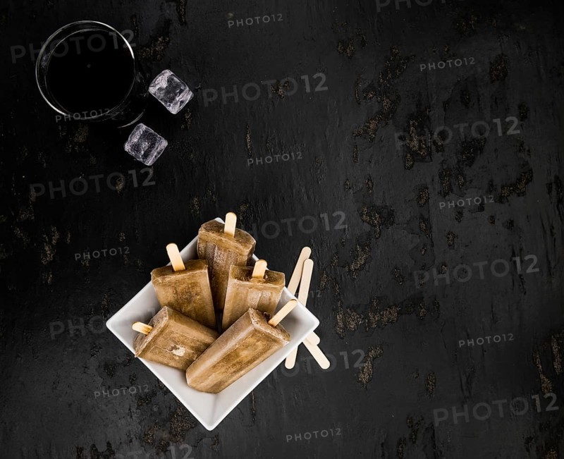 Cola Popsicles (selective focus) on a vintage background as detailed close-up shot