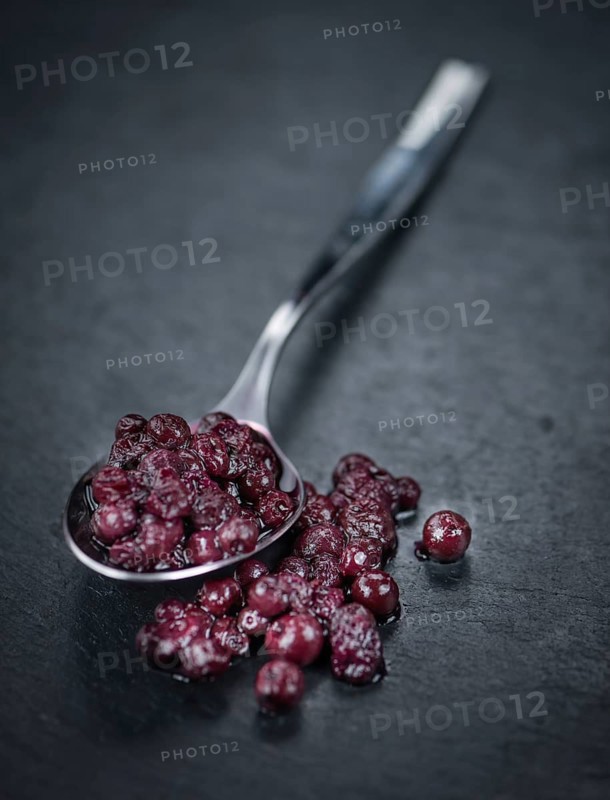 Preserved Blueberries on a vintage background as detailed close-up shot, selective focus